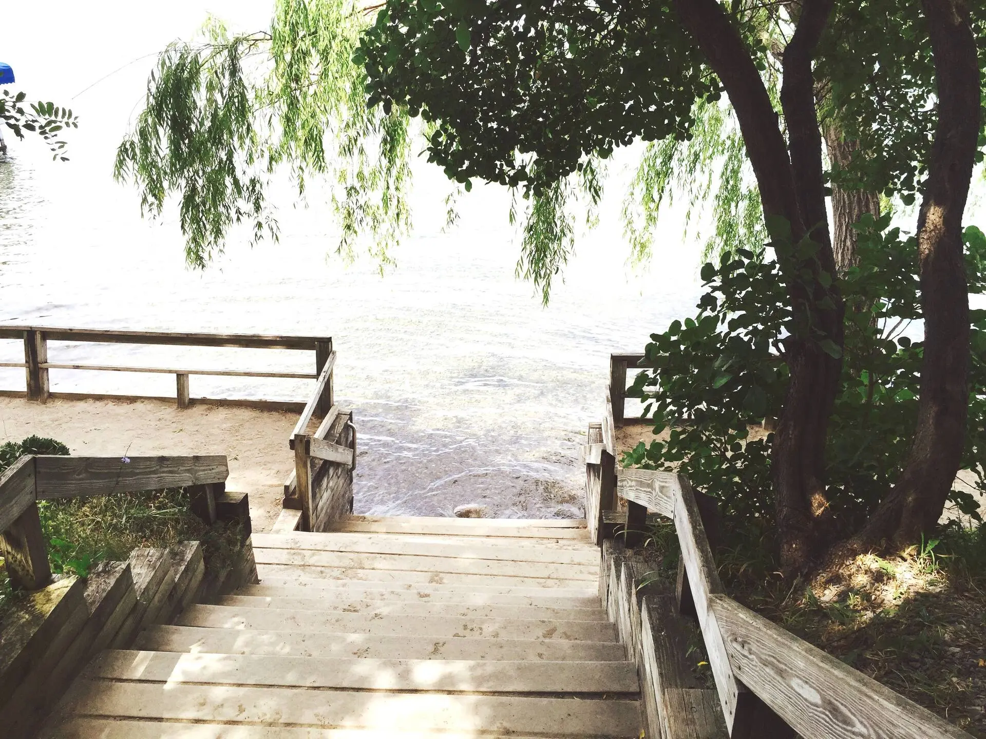 Wooden stairs descending to the private beach and lake