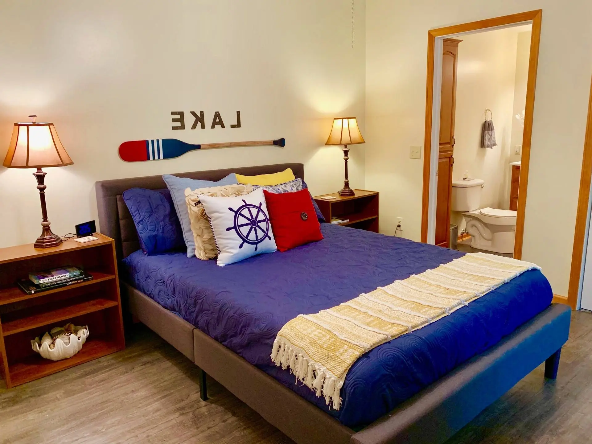 Blue king-size bedroom with an ensuite bathroom and lake-themed decor